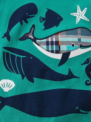 Toddler tee with navy whale and plaid whale print on teal cotton.