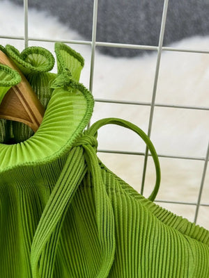 Lime green pleated midi dress with ruffled neckline and tie detail.