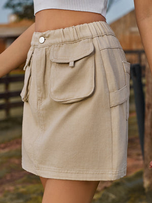 Khaki denim mini skirt with elastic waist and buttoned cargo pockets.
