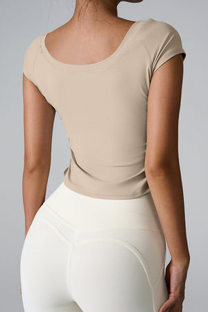 Sand performance tee with gathered side detail, short sleeves, and scoop neck.