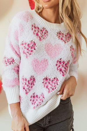 Fuzzy heart jacquard sweater in blush pink with pearl embellishments.
