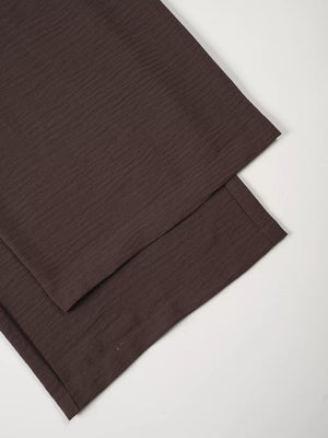 Chocolate textured cropped vest and wide-leg pants ensemble detail