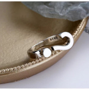 Sterling silver open ring with a question mark design and a small circle detail.