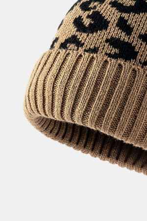 Beige acrylic beanie with black leopard print and ribbed cuff.