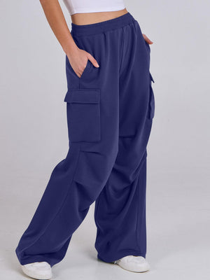 Royal blue sweatpants with cargo pockets and a wide leg, shown on a model.