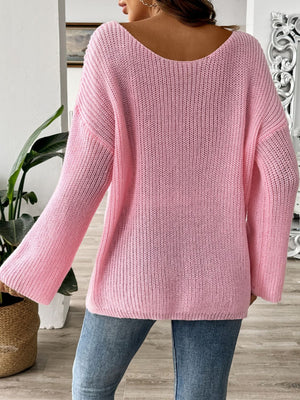Dusty pink ribbed knit pullover sweater with an off-the-shoulder neckline and long sleeves.