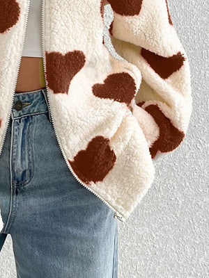 Heart print sherpa zip-up jacket in brown and white, with a fuzzy texture.