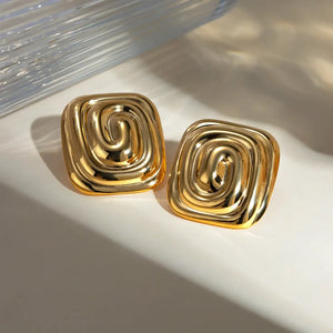 Gold sculpted swirl square earrings with a polished finish.
