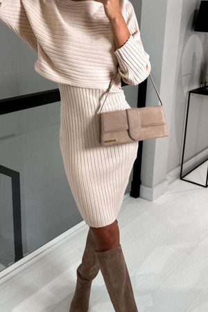 Ribbed knit midi dress in a light neutral color, featuring a sculpted silhouette and long sleeves.