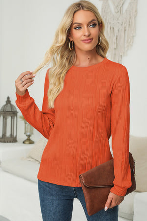 Orange textured wave crewneck pullover with long sleeves.