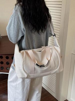 Off-white nylon travel duffle bag with curved stitching and adjustable strap.