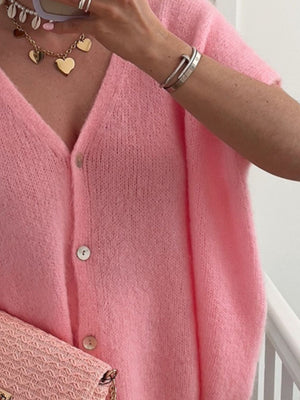 Pink mohair blend cardigan with cap sleeves and button front.