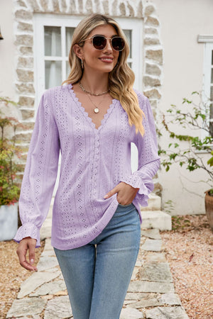 Lavender eyelet lace blouse with ruffle sleeves and V-neckline.