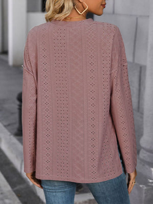 Dusty pink perforated henley shirt with slit hem and long sleeves.