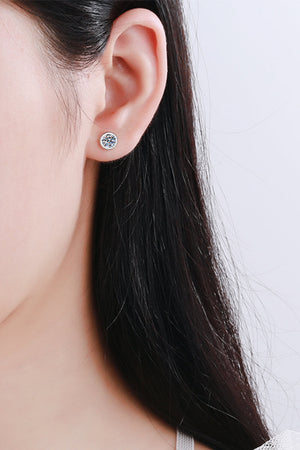 Prismatic Halo stud earrings in silver feature a round, clear gemstone.