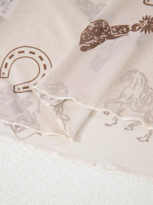 Sheer mesh mock neck shirt in cream with brown Western print, featuring horseshoes and spurs.