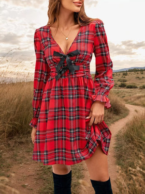 Red plaid mini dress with deep v-neck and black bow detail