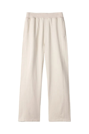 Beige seamed lounge trousers with a relaxed fit and elastic waistband.
