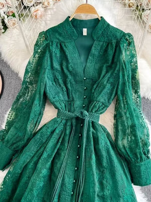 Green lace maxi dress with balloon sleeves, tie waist, and button front.
