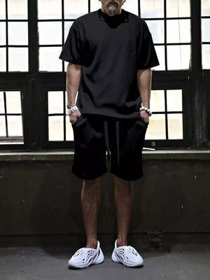 Black ribbed t-shirt and drawstring shorts set for men, casual comfort style.