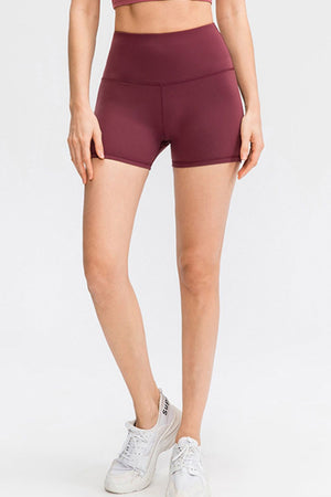 Burgundy athletic shorts with a high waist and sculpted fit.
