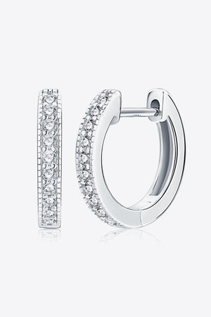 Silver pave-set huggie hoop earrings with sparkling stones.