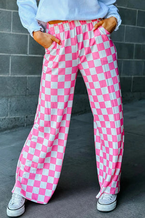 Checkerboard palazzo trousers in fuchsia pink and white with a wide leg and elastic waist.