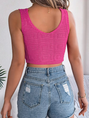 Hot pink knit crop top with a textured geometric pattern and a V-neck.