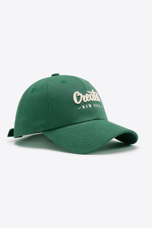 Green baseball cap with embroidered "Create New Life" text detail