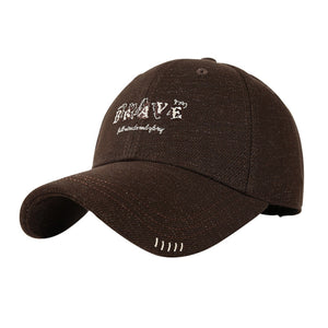Brown cotton baseball cap with embroidered "BRAVE" text and subtle stitching detail.
