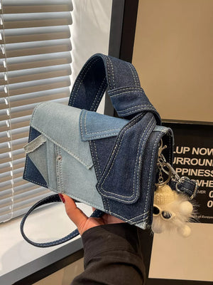 Artisanal denim crossbody bag with patchwork design and fluffy keychain detail.
