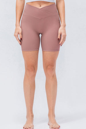 Cross-waist ribbed bike shorts in Dusty Pink with a textured waistband detail.