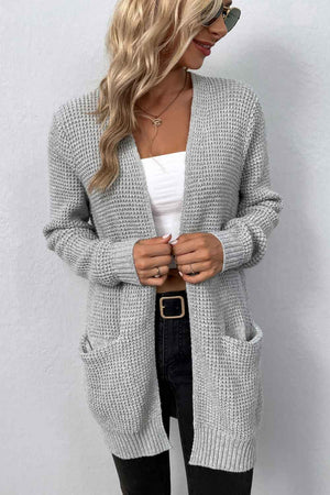 Light gray waffle knit longline cardigan with pockets and open front.
