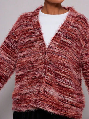 Cozy textured knit cardigan in a marled rust and pink blend with a V-neck and button front.