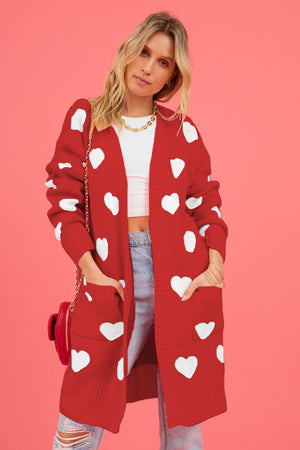 Red longline knit cardigan with white heart pattern, open front, pockets, acrylic.