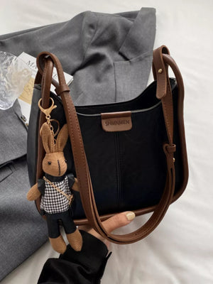Black pu leather shoulder bag with brown piping and bunny charm