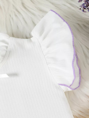 White baby top with purple ruffle trim on sleeves and neckline detail.