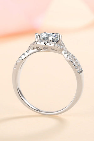 Silver moissanite engagement ring with halo and pave band.