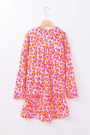 Pink leopard print satin pajama set with collared top and shorts.
