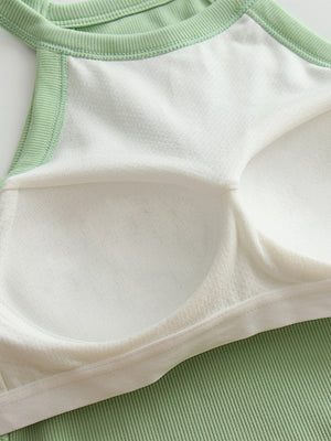 Ribbed halter crop top in Gum Leaf green with white lining and contrast stitching detail.