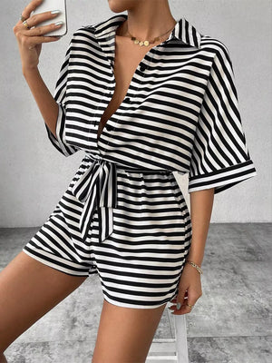 Black and white striped belted romper with collared button-front top and short sleeves.