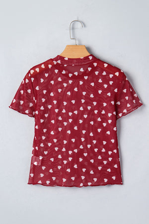 Deep red sheer mesh t-shirt with white heart print, short sleeves, and lettuce hem.