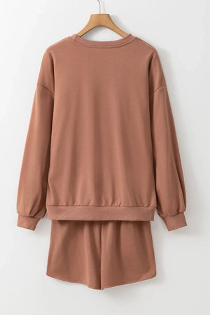 Taupe loungewear set with crewneck sweatshirt and shorts.
