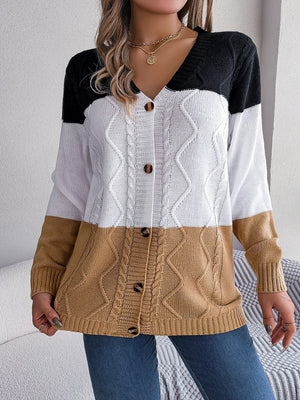 Colorblock cable knit cardigan with button front in camel, white, and black acrylic.