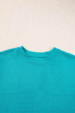 Turquoise textured co-ord set with geometric pattern and crew neck.