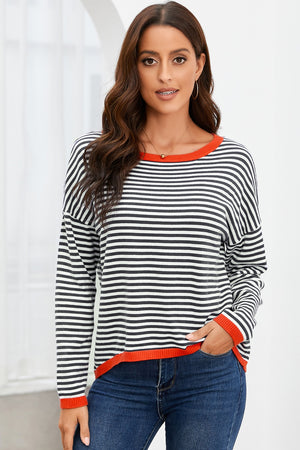 Striped knit crewneck sweater with contrast red trim and long sleeves.