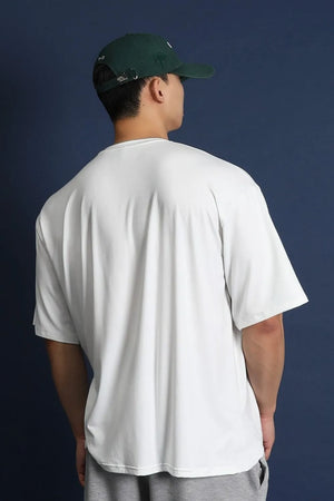 White oversized crew neck t-shirt with a modern silhouette, short sleeves, and a relaxed fit.