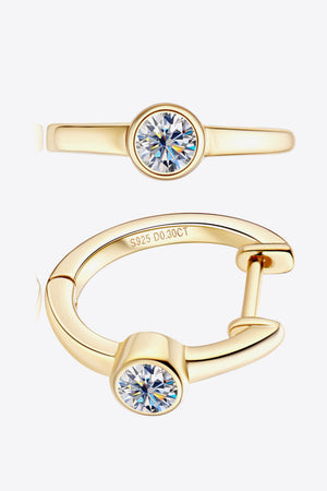Gold bezel-set sparkle huggie hoop earrings with a single diamond accent.