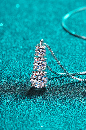Silver moissanite pendant with three cascading stones on a box chain necklace.