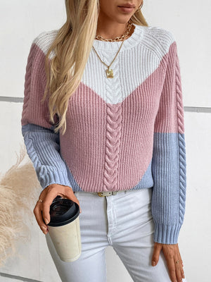 Chevron cable knit sweater in pastel blue, blush pink, and white colorblock with cable knit details.